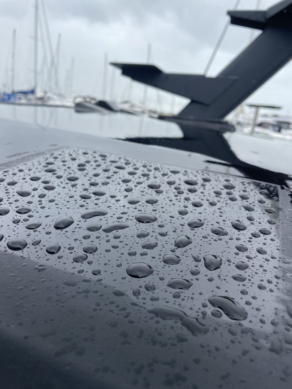 Rainwater beading on a coated black hull