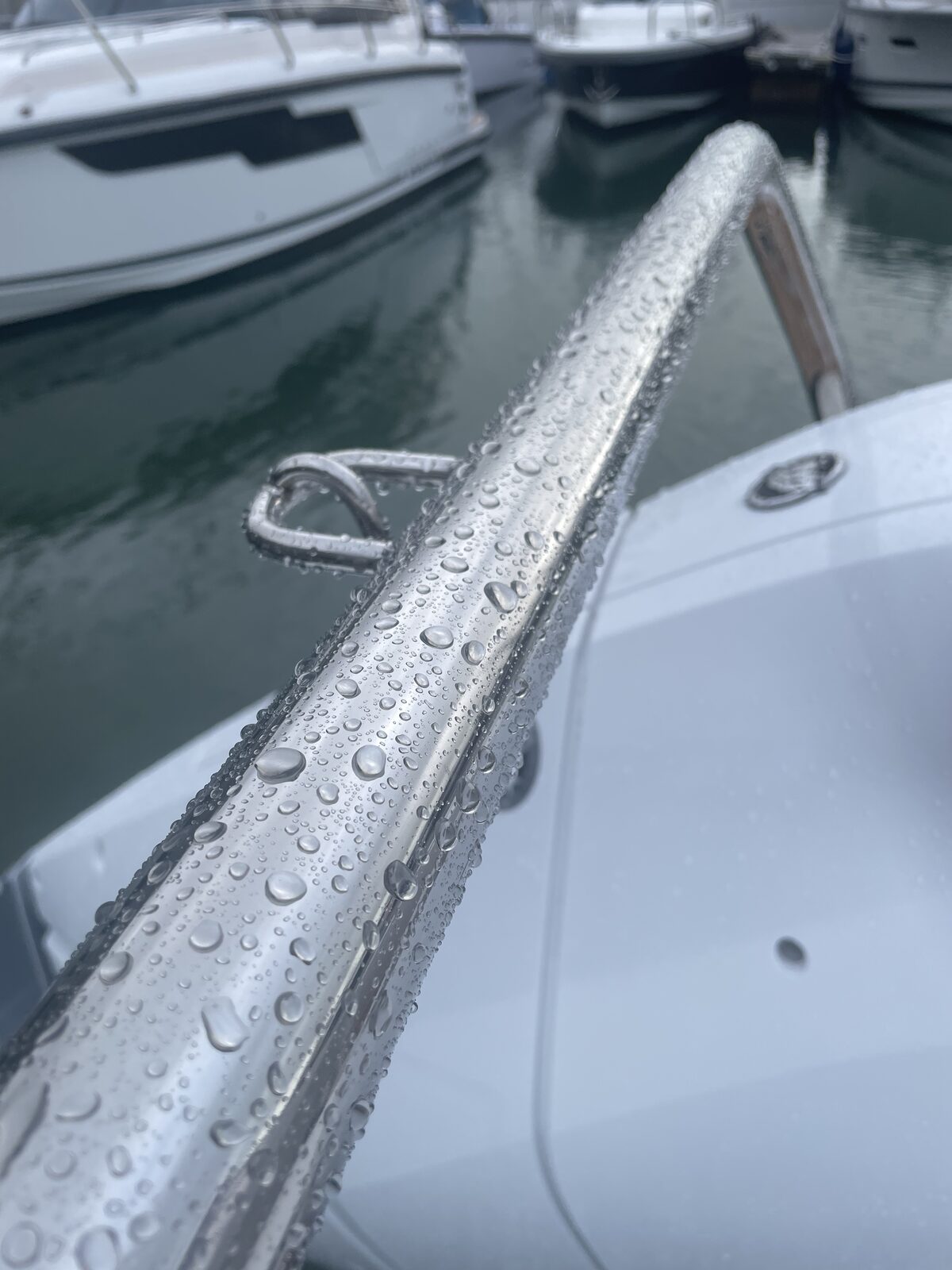 Water beading on stainless rail of a coated boat
